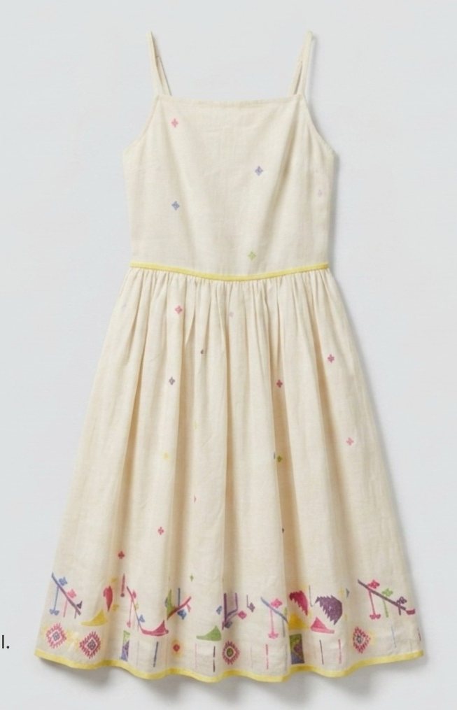 Flat lay of a cream embroidered sundress