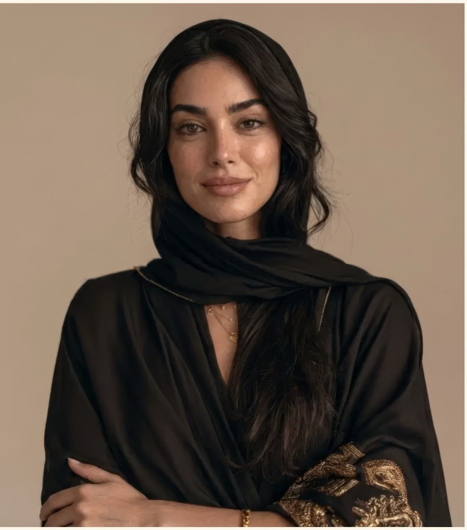 Portrait of a woman in a black abaya with gold embroidery